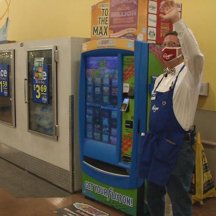 Terry Rush waves to fellow employees at Dixie Highway Kroger